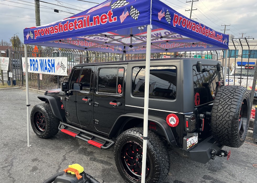 Jeep Wrangler with red trim under the Pro Wash sign after an exterior wash, Washington DC